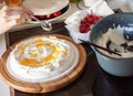 Preparing pavlova cake at home female hands