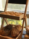 Image of breads, pastries, neatly arranged on baskets and shelves.