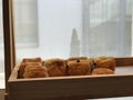 Image of breads, pastries, neatly arranged on baskets and shelves.