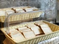 Image of breads, pastries, neatly arranged on baskets and shelves.