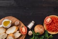 Preparing delicious Italian tomato bruschetta with chopped vegetables, herbs and oil Royalty Free Stock Photo