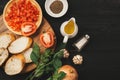 Preparing delicious Italian tomato bruschetta with chopped vegetables, herbs and oil Royalty Free Stock Photo