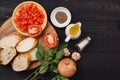 Preparing delicious Italian tomato bruschetta with chopped vegetables, herbs and oil Royalty Free Stock Photo