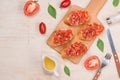 Preparing delicious Italian tomato bruschetta with chopped vegetables, herbs and oil Royalty Free Stock Photo