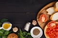 Preparing delicious Italian tomato bruschetta with chopped vegetables, herbs and oil