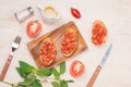 Preparing delicious Italian tomato bruschetta with chopped vegetables, herbs and oil Royalty Free Stock Photo