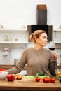 Peaceful good-looking woman with tied hair having calm evening