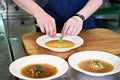 Preparing dishes - vegetable soup on restaurant kitchen