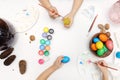 Preparing for Easter. Children paint on eggs. View from above on a white background Royalty Free Stock Photo