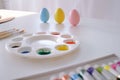 preparing for Easter. Painting easter eggs on colorful tablecloth background. Royalty Free Stock Photo