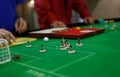 Preparing figures to play during Table soccer world championship game detail