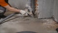 Worker vacuuming concrete floors. Preparing the floor for waterproofing. construction cleaning with an industrial vacuum cleaner.