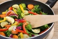 Preparing food vegetables in cooking pan with spatula