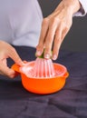 Preparing fresh lemon juice squeezed with hand juicer Royalty Free Stock Photo