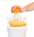 Preparing fresh orange juice with juicer