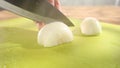 preparing fresh vegetables. slicing onions on a cutting board. healthly food. Royalty Free Stock Photo