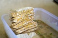 Preparing fried tempeh or in Indonesia tempe mendoan with seasoning flour.