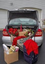 Packing car with Christmas gifts, suitcases ready to get away for the holidays. Royalty Free Stock Photo