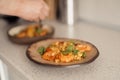 Preparing gourmet shrimp pasta dish with fresh basil garnish Royalty Free Stock Photo