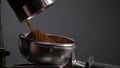 Preparing ground coffee electric grinder close up. Powder pouring in portafilter Royalty Free Stock Photo