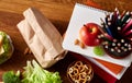 Preparing ham sandwiches for scool lunchbox on wooden background, close up.