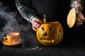 Preparing for the holiday - Halloween lantern cut out of pumpkin close-up. Burning candle in a man is hand Royalty Free Stock Photo