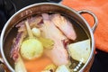 Preparing homemade chicken soup - broth. Pot on the stove in the kitchen with ingredients for cooking. Royalty Free Stock Photo