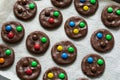 Preparing homemade chocolate cookies decorated with colored candy drops Royalty Free Stock Photo