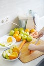 Preparing homemade fresh juice made with apples, oranges and carrots Royalty Free Stock Photo