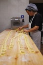 Preparing Italian Stuffed Tortelli on a Long Wooden Table