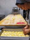 Preparing Italian Stuffed Tortelli on a Long Wooden Table
