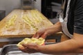 Preparing Italian Stuffed Tortelli on a Long Wooden Table