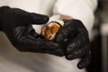 Chef making traditional sushi nigiri Unagi with eel in black gloves. Close up of sushi chefÃ¢â¬â¢s hands.