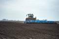 Preparing land and fertilizing. Seedbed cultivator in farmlands