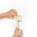 Preparing light switch with masking tape for painting. Professional interior construction worker