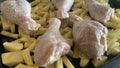 Preparing marinated meat for cooking in the oven. The meat and the potatoes with salt and black pepper.