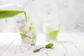 Preparing matcha green tea affogato with vegan coconut ice cream.