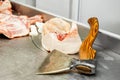 Preparing meat for sale in a butcher shop. Old axe for butchering carcasses. Selective focus Royalty Free Stock Photo