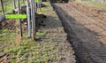 Preparing a new path by removing a layer of soil. the space will be filled with stones and gravel. asphalt is rolled on top. the s