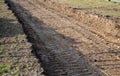 Preparing a new path by removing a layer of soil. the space will be filled with stones and gravel. asphalt is rolled on top. the s