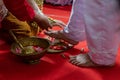 Preparing for Ngidak tagan or Nincak ndog, the ritual of stepping on raw chicken eggs by the groom at a traditional Javanese weddi