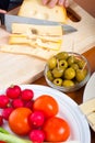 Preparing olives and emmenthal cheese Royalty Free Stock Photo