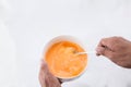 Preparing omelet .Cooking of eggs in White Ceramic Bowl. Royalty Free Stock Photo