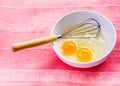 Preparing omelet with eggs and whisk Royalty Free Stock Photo