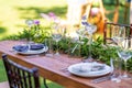 Preparing for an open-air party. Decorated with fresh flowers served tables. Table number. Decoration Details Royalty Free Stock Photo