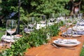 Preparing for an open-air party. Decorated with fresh flowers served tables. Table number. Decoration Details Royalty Free Stock Photo