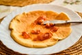 Greasing pancake with marmalade