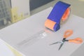 Preparing parcel for shipping with scissors and scotch tape cutter. Royalty Free Stock Photo