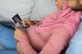 Preparing For Parenthood. Happy Black Pregnant Muslim Couple Looking At Baby Sonography Royalty Free Stock Photo