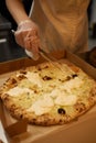 Preparing Pizza Margherita on a marble countertops.Pizzaiolo puts pizza dough on the peel. Royalty Free Stock Photo